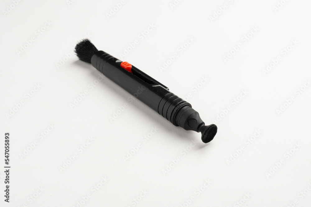 Lens pen for camera and lens cleaning. Made plastic with soft brush and smooth sticky rubber to remove dirty dust from lens surface. Lens pen for camera and lens cleaning. Made plastic with soft brush and smooth sticky rubber to remove dirty dust from lens surface.