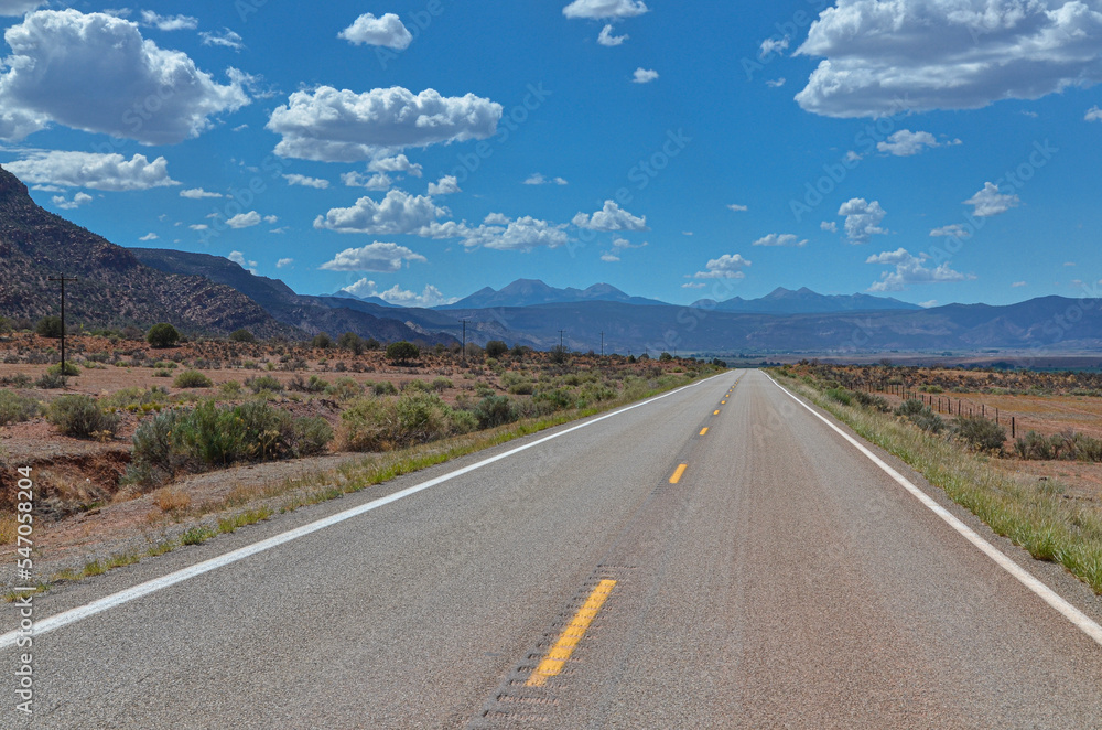 State Highway 90 passing Paradox Valley with La Sal mountains at the background (Montrose County, Colorado, USA)