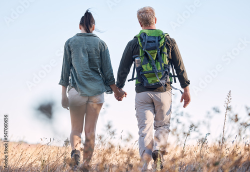 Couple, holding hands and travel or backpack adventure in bonding relationship together in the countryside. Hands of man and woman backpacking, trekking or walking in care or support for traveling