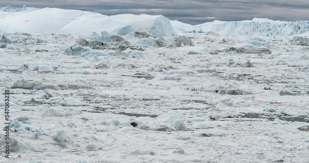 Icebergs and ice from glacier in arctic nature landscape on Greenland. Video of icebergs in Ilulissat icefjord. Affected by climate change and global warming Icebergs and ice from glacier in arctic nature landscape on Greenland. Video of icebergs in Ilulissat icefjord. Affected by climate change and global warming