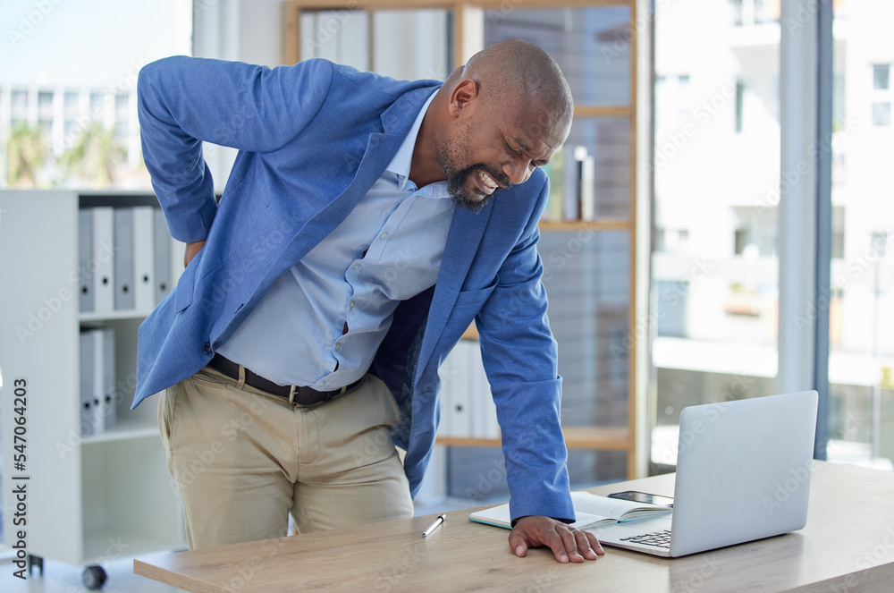 Back pain, spine and injury with businessman at desk for burnout, muscle and fatigue. Overworked, stress and accident with black man and body ache for exhausted, tired and inflammation problem