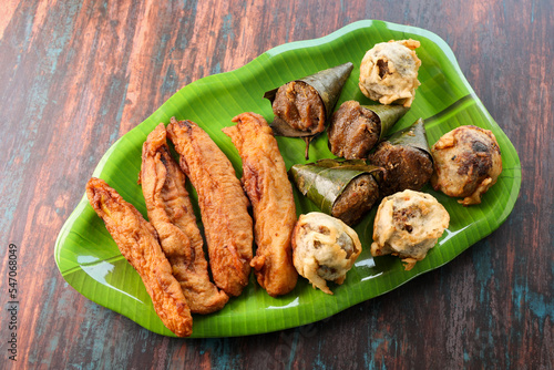 Sukhiyan or Sugiyan banana fry pazham pori Ila Ada Sweet rice dumplings Elayada steamed rice cakes wrapped in banana leaves famous breakfast or tea snacks of Kerala India. photo