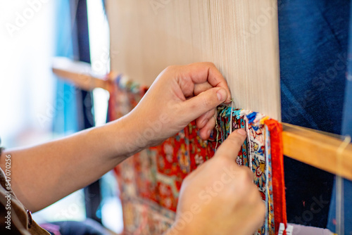 The silk carpets are knotted by hand in Uzbekistan. They are fine and expensive. photo