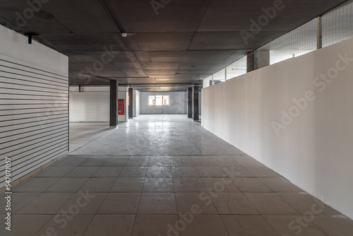 Empty retail space with a black ceiling and a dirty floor, immediately after repair photo