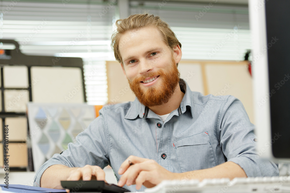 businessman with calculator in an office businessman with calculator in an office