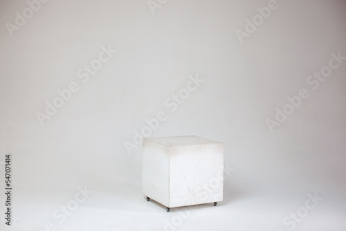 Cube on white background on cyclorama. Photo studio. 