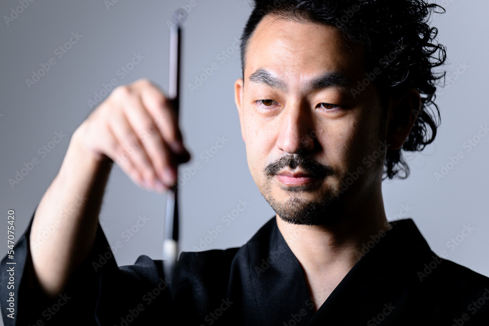 Image like a Japanese calligrapher 「shodo」holding a brush. closeup Image like a Japanese calligrapher 「shodo」holding a brush. closeup