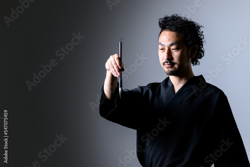 Image like a Japanese calligrapher「shodo」 holding a brush. photo