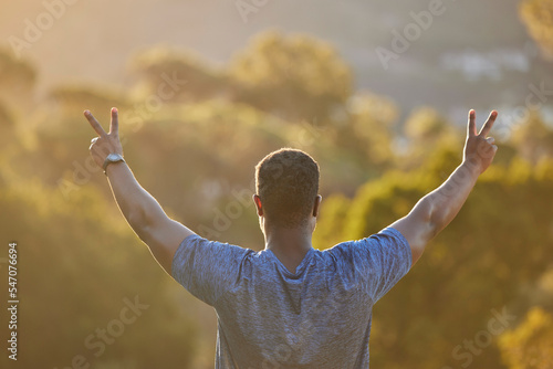 Hands, peace and back with a sports black man outdoor in nature for exercise, fitness or training. Workout, motivation and view with a male athlete cheering reaching a goal or target for health