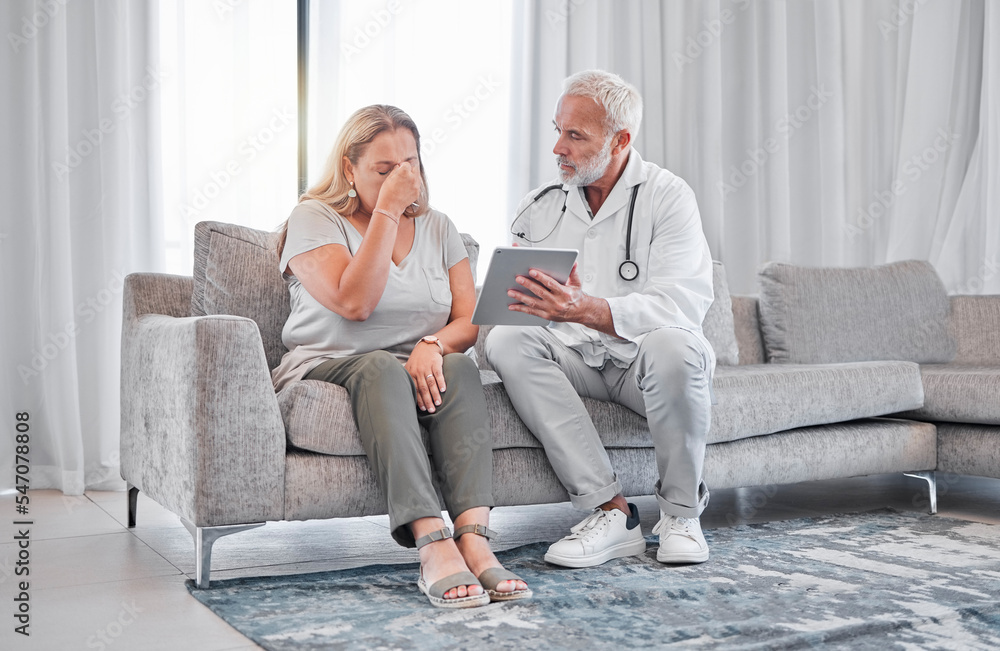 Doctor, tablet and bad news with a woman patient in the living room of her home with a medicine professional. Healthcare, insurance and cancer diagnosis with a female and male health consultant Doctor, tablet and bad news with a woman patient in the living room of her home with a medicine professional. Healthcare, insurance and cancer diagnosis with a female and male health consultant