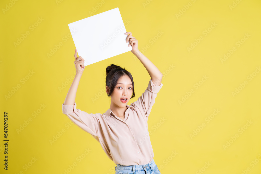 image of a pretty asian girl holding a white billboard image of a pretty asian girl holding a white billboard