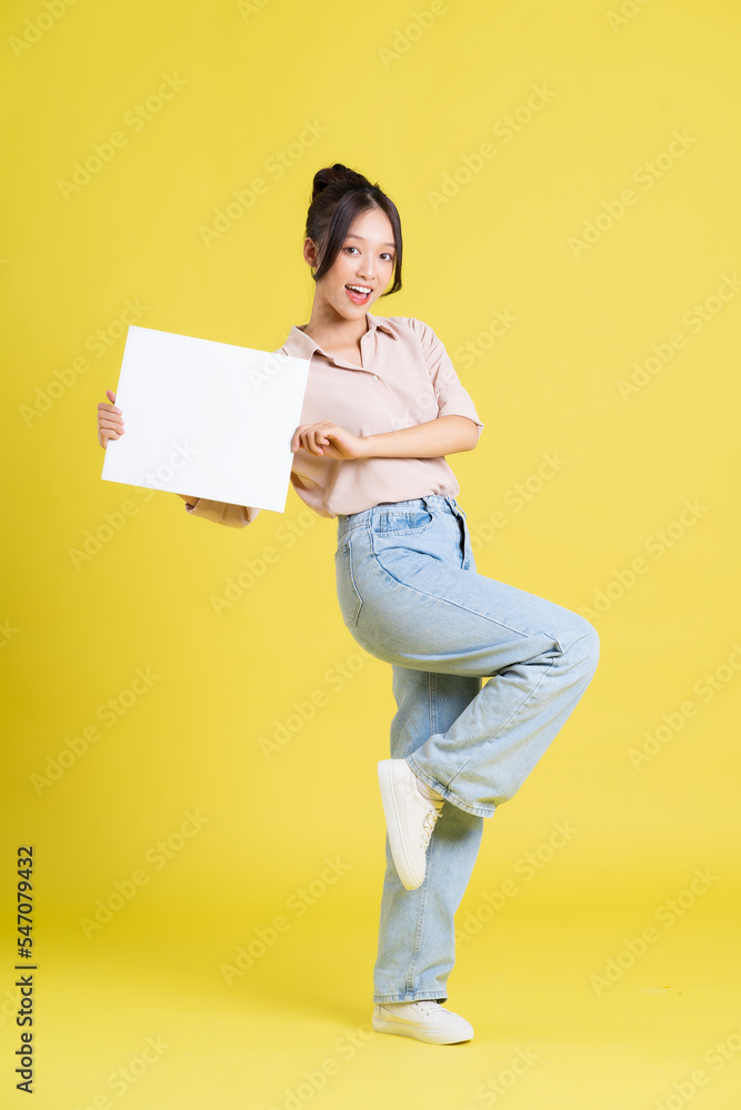 image of a pretty asian girl holding a white billboard image of a pretty asian girl holding a white billboard