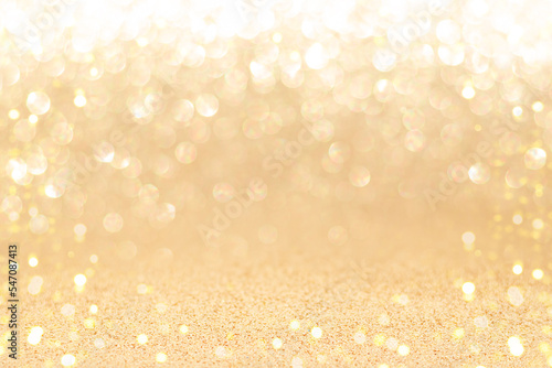 Golden sparkling background with shiny blurred round bokeh.