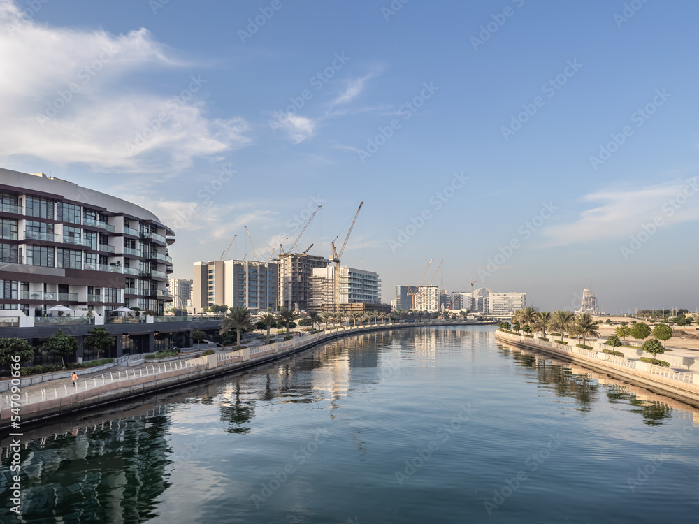 Residential apartment buildings under construction along the waterfront promenade in Al Raha Beach, Abu Dhabi