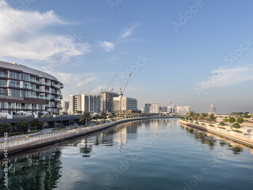 Residential apartment buildings under construction along the waterfront promenade in Al Raha Beach, Abu Dhabi
