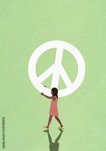 Girl carrying large peace sign
 photo