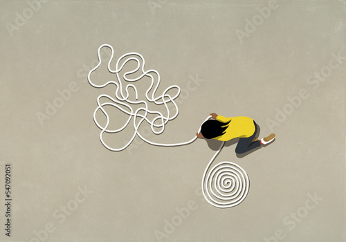 Girl untangling rope into a coil
 photo