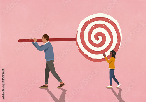 Father and daughter carrying large lollipop on pink background
 photo