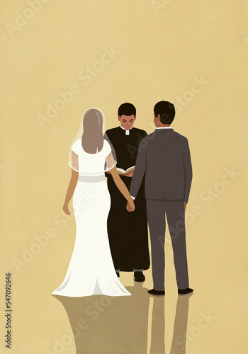 Priest presiding over wedding of bride and groom
 photo