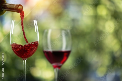 Classic glasses with wine at vineyard background