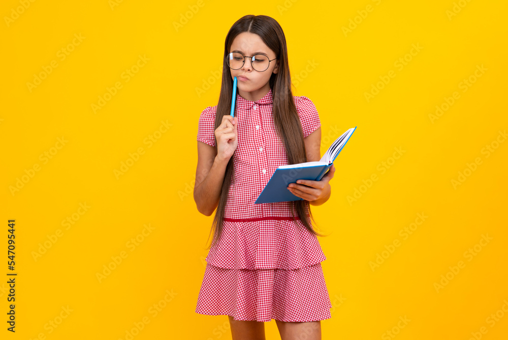 Teen girl pupil hold books, notebooks, isolated on yellow background, copy space. Back to school, teenage lifestyle, education and knowledge. Thinking pensive clever teenager girl. Teen girl pupil hold books, notebooks, isolated on yellow background, copy space. Back to school, teenage lifestyle, education and knowledge. Thinking pensive clever teenager girl.