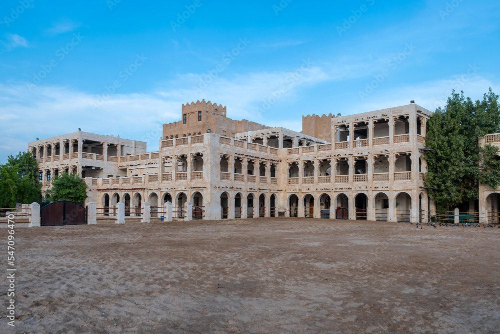 Historic building housing stables with Arabian horses near Falcon Souq in Doha, Qatar.
