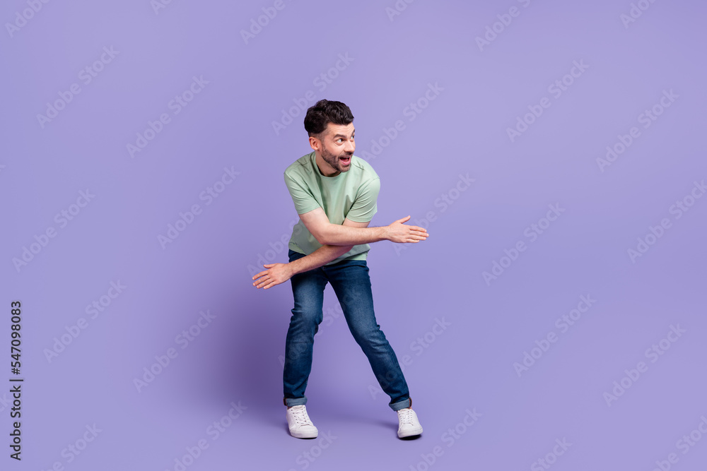 Full length photo of funky good mood boy person look empty space hand crossed dancing nightclub isolated on purple color background