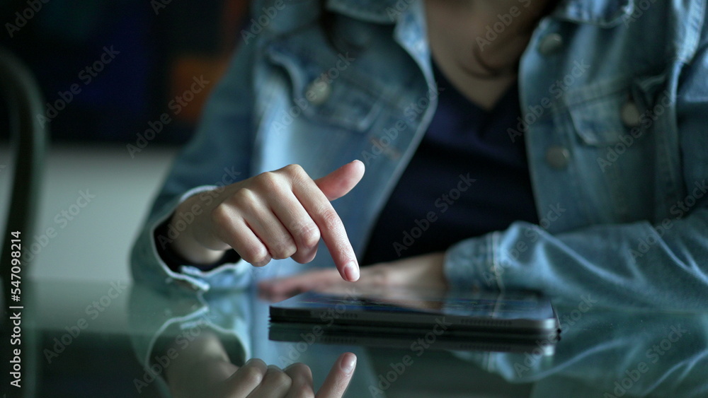 Woman browsing internet shopping on tablet device. Person scrolling content online