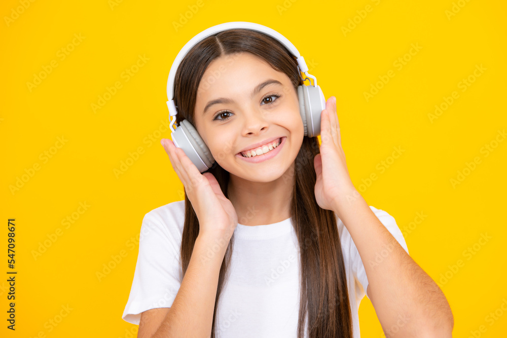 Happy teenager portrait. Funny kid girl 12, 13, 14 years old listen music with headphones. Teenage girl with headphones listening songs on headset earphone. Smiling girl. Happy teenager portrait. Funny kid girl 12, 13, 14 years old listen music with headphones. Teenage girl with headphones listening songs on headset earphone. Smiling girl.