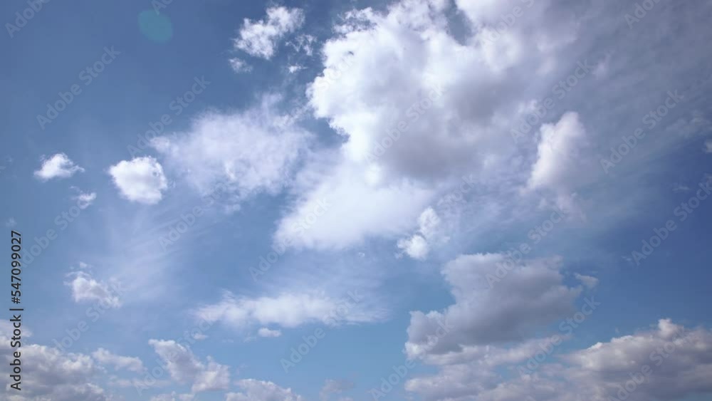 Beautiful timelapse of white clouds moving fast in the sky on a clear day Beautiful timelapse of white clouds moving fast in the sky on a clear day