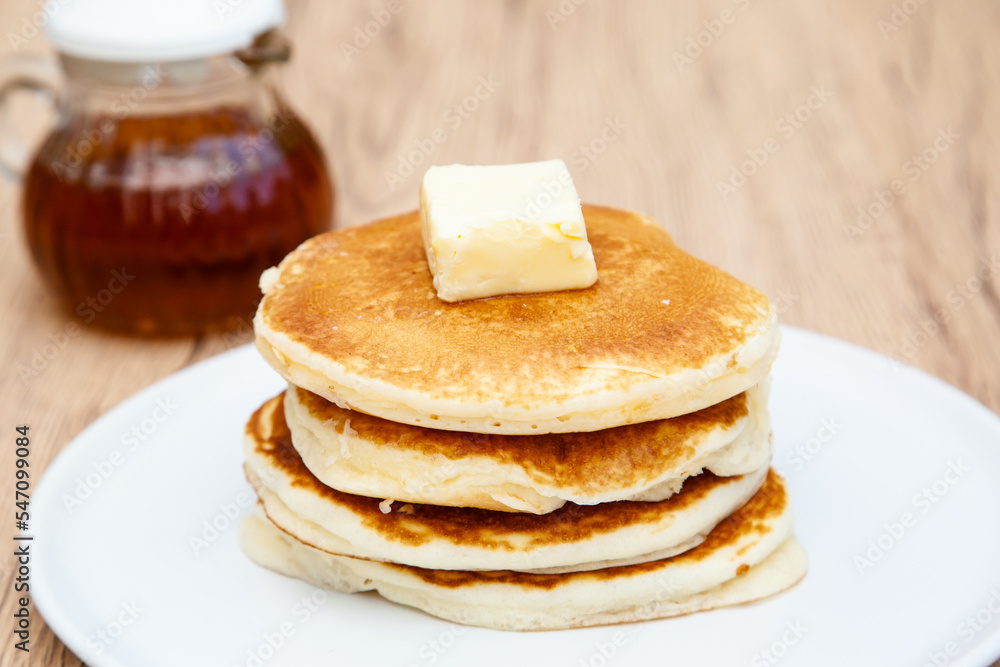 Stack of freshly made buttermilk pancakes with maple syrup and butter Stack of freshly made buttermilk pancakes with maple syrup and butter
