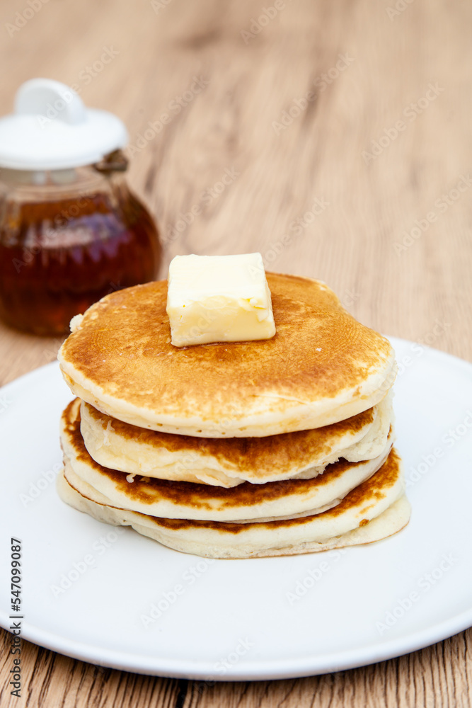 Stack of freshly made buttermilk pancakes with maple syrup and butter Stack of freshly made buttermilk pancakes with maple syrup and butter