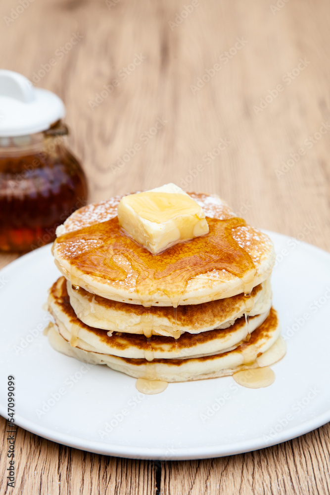 Stack of freshly made buttermilk pancakes with maple syrup and butter Stack of freshly made buttermilk pancakes with maple syrup and butter