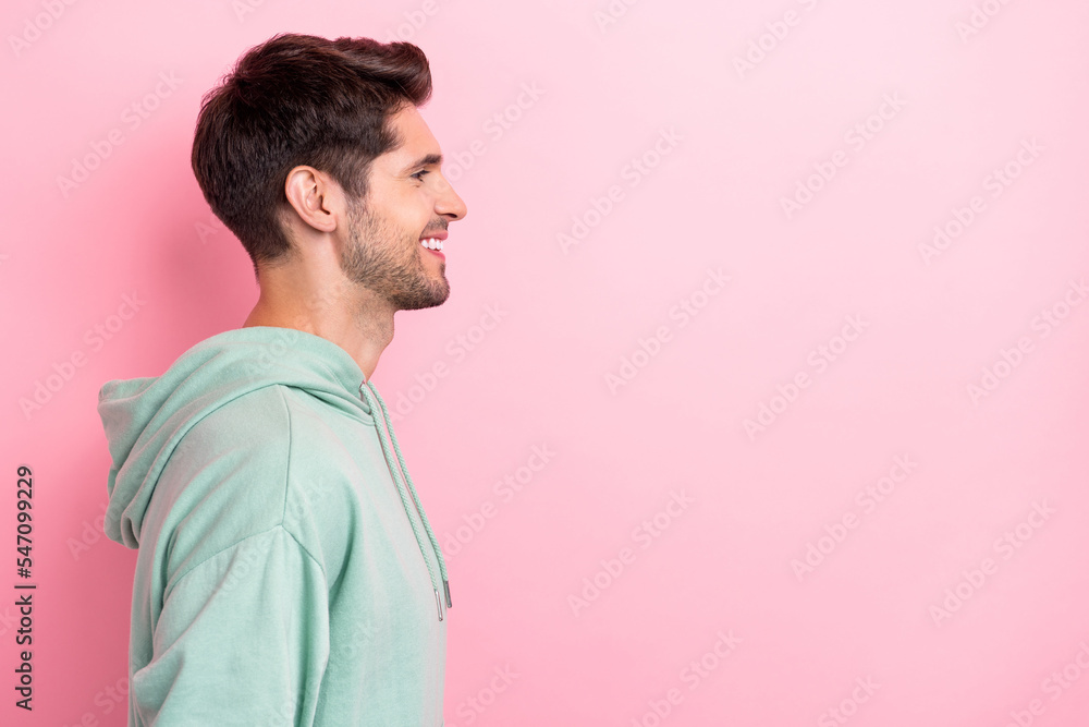 Side profile photo of successful positive man student wear khaki hoodie toothy beaming smile looking empty space barbershop isolated on pink color background Side profile photo of successful positive man student wear khaki hoodie toothy beaming smile looking empty space barbershop isolated on pink color background