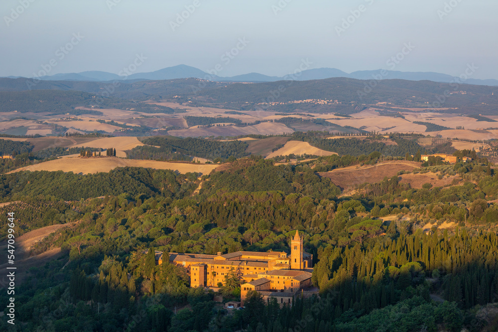 Sunrise view of the Abbey of Monte Oliveto Maggiore, a large Benedictine monastery in Tuscany, Italy
