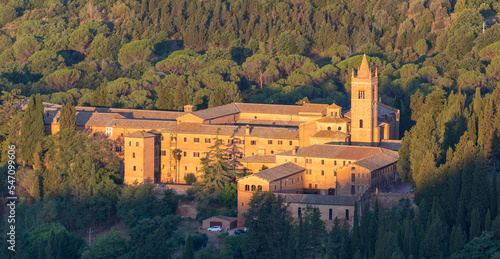 Sunrise view of the Abbey of Monte Oliveto Maggiore, a large Benedictine monastery in Tuscany, Italy photo