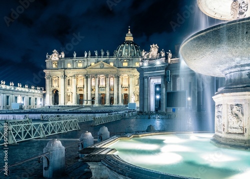 Fountain in front of the Peter's Basilica in Saint Peter's Square at night, Rome, Italy