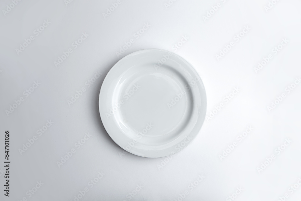Top view of empty white plate isolated on white background Top view of empty white plate isolated on white background