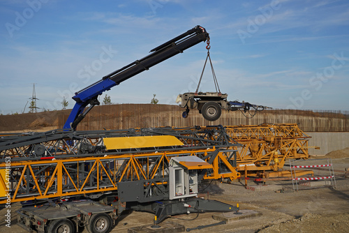 Folding crane mounting on a bridge construction site for the overpass of a service road over the future A143 motorway photo