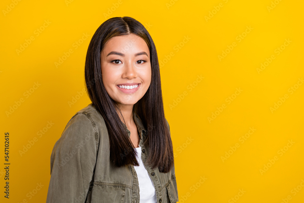 Portrait of nice glad girl with long hairstyle dressed khaki shirt smiling stomatology clinic ad isolated on yellow color background Portrait of nice glad girl with long hairstyle dressed khaki shirt smiling stomatology clinic ad isolated on yellow color background