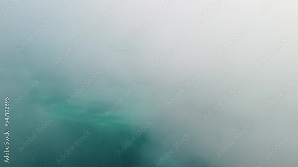 Aerial view from above on calm azure sea and volcanic rocky shores. Small waves on water surface in motion blur. Nature summer ocean sea beach background. Nobody. Holiday, vacation and travel concept Aerial view from above on calm azure sea and volcanic rocky shores. Small waves on water surface in motion blur. Nature summer ocean sea beach background. Nobody. Holiday, vacation and travel concept