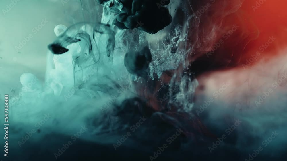 Slow motion shot of colorful paint ink exploding blast underwater,close up