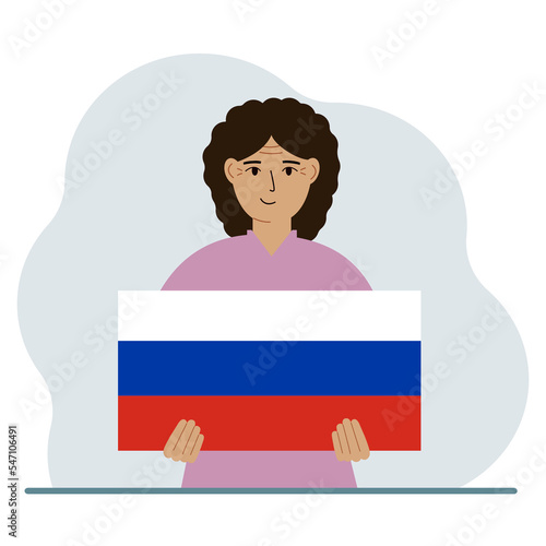 A woman holds a Russian flag in his hands. The concept of demonstration, national holiday or patriotism. Nationality.