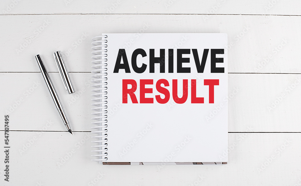 ACHIEVE RESULTS text written on notebook on the wooden background ACHIEVE RESULTS text written on notebook on the wooden background