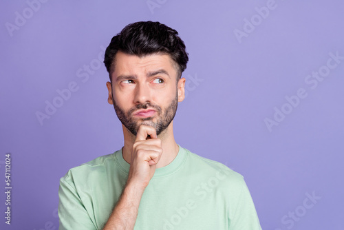 Close up photo of intelligent minded man look empty space finger touch chin consider plan idea question isolated on purple color background