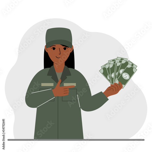 Military woman holds a lot of money in his hand. The concept of payment for military service or service in the army under a contract.