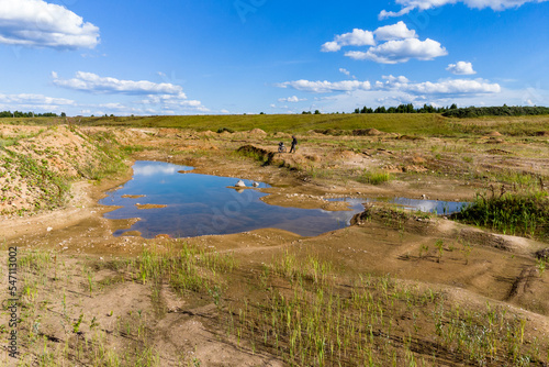 Landscape with a view of a sandy landscape and large puddles after the rains