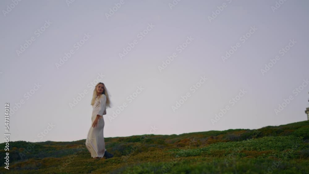Exquisite girl stepping hilltop evening alone. Tender lady walking valley sunset Exquisite girl stepping hilltop evening alone. Tender lady walking valley sunset