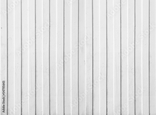 White concrete wall texture with vertical scratched plaster lines