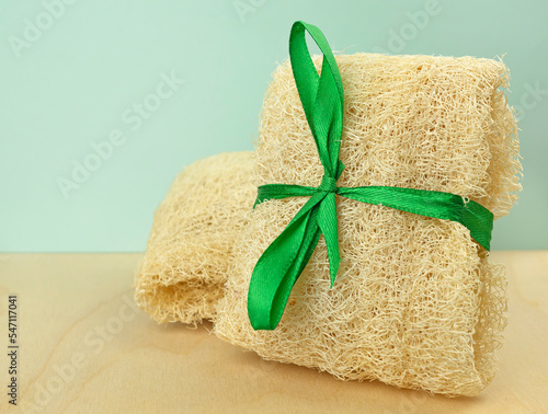 The loofah sponges. Vegetable sponge extracted from the loofah plant on a wooden background. Eco-friendly sponges, waste-free production. A way of life, the concept of no plastic and eco-friendly